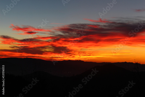 Red and orange sunset with mountains © AlejandroJess