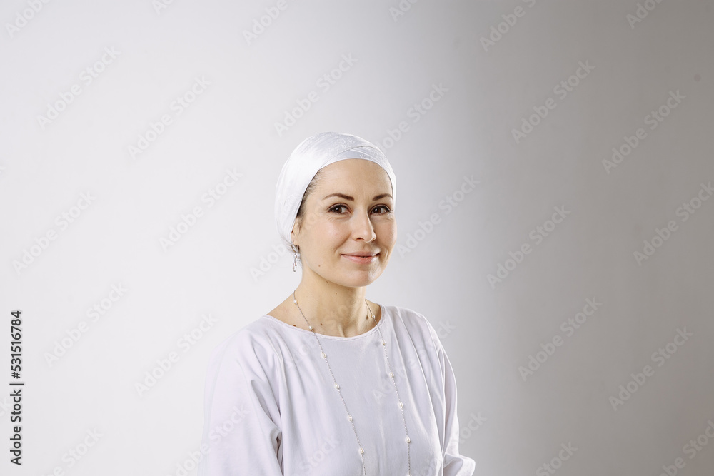 A girl in white clothes does yoga in a white room A girl in white clothes does yoga in a white room