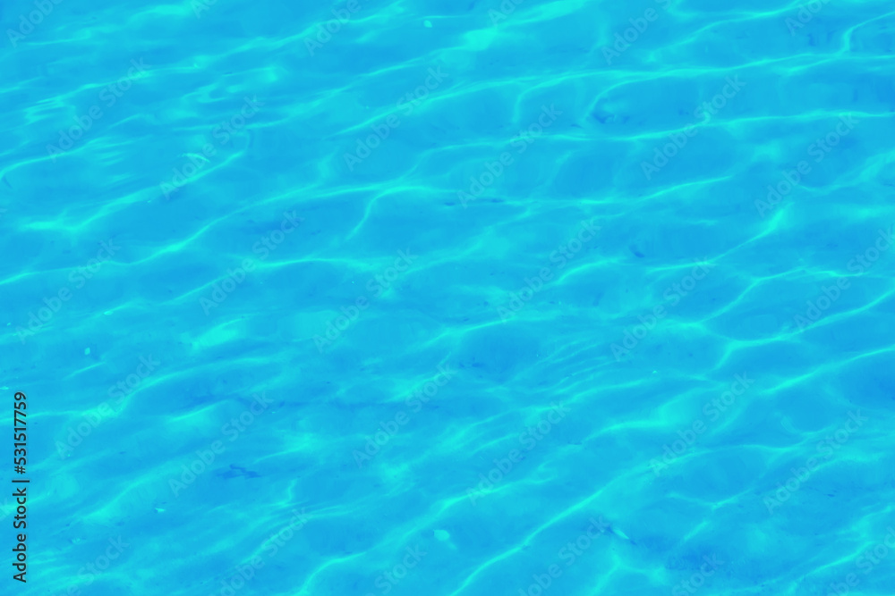 Water ripple texture background. Wavy water surface. Blue sky reflected in the water.