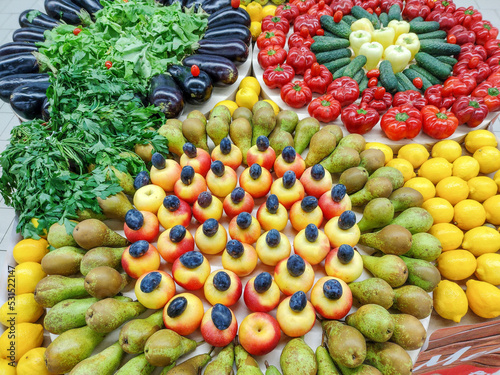 Beautiful fruit and vegetable decoration. Pears, apples, plums, lemons, parsley, eggplant, peppers, cucumbers photo