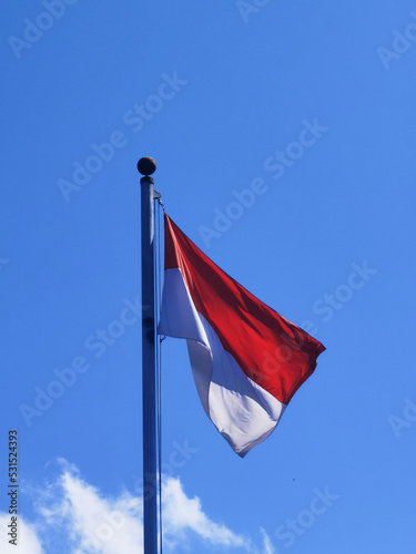 Indonesia Flag with Blue Sky Background