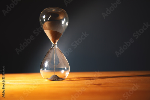 Hourglass on the table. photo