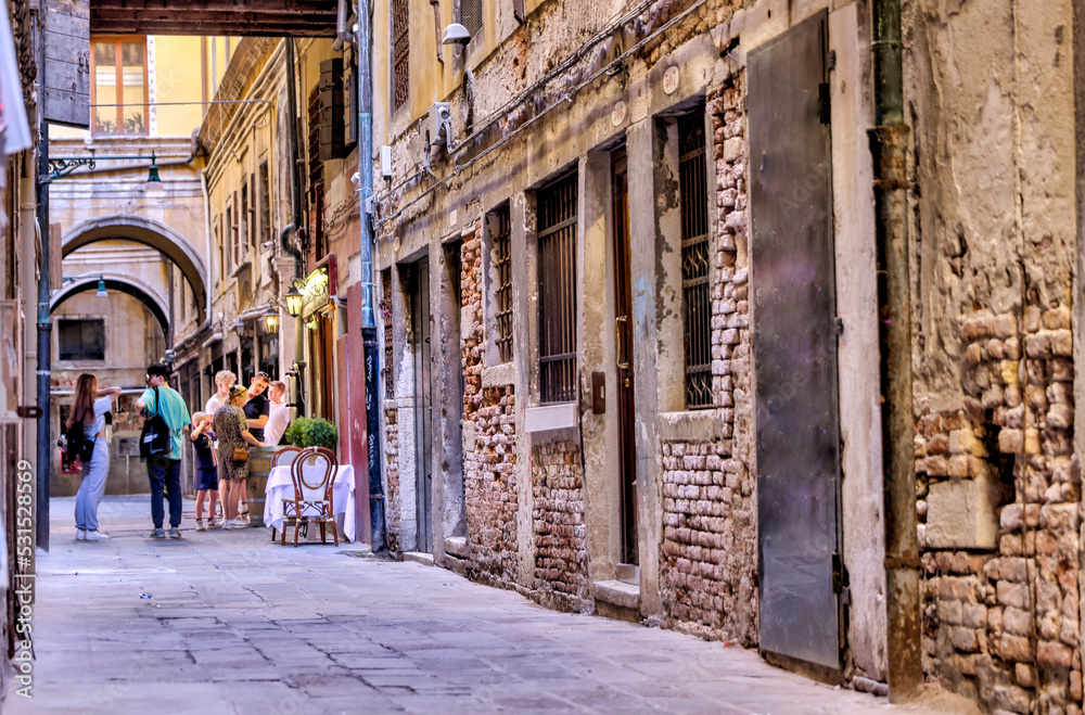 Fototapeta premium Venice, Italy - July 5, 2022: Building exteriors along the canals in Venice Italy 