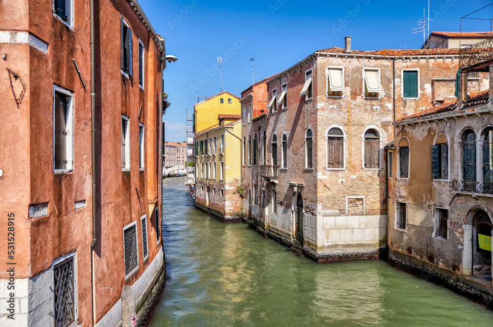 Venice, Italy - July 5, 2022: Building exteriors along the canals in Venice Italy
