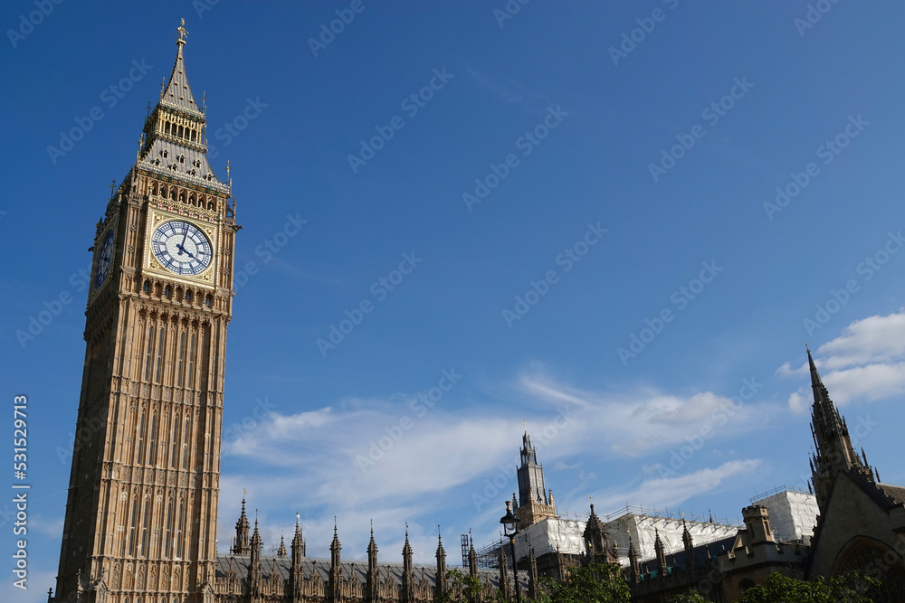 Elizabeth Tower, known as Big Ben, rising into a blue sky above the Houses of Parliament in Westminster, London, UK. Elizabeth Tower, known as Big Ben, rising into a blue sky above the Houses of Parliament in Westminster, London, UK.