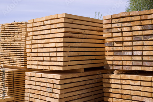 Stack of fresh pine boards in a sawmill warehouse. Harvesting, sale of lumber for construction	