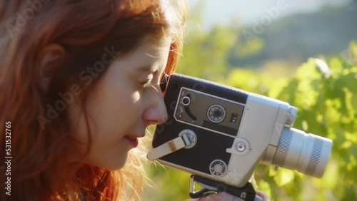 Girl in the nature recoding a vintage video  photo