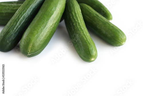 Isolated Heap of green Cucumbers, group of fresh cucumbers on the white background. Close-up, top view, macro, copy space
