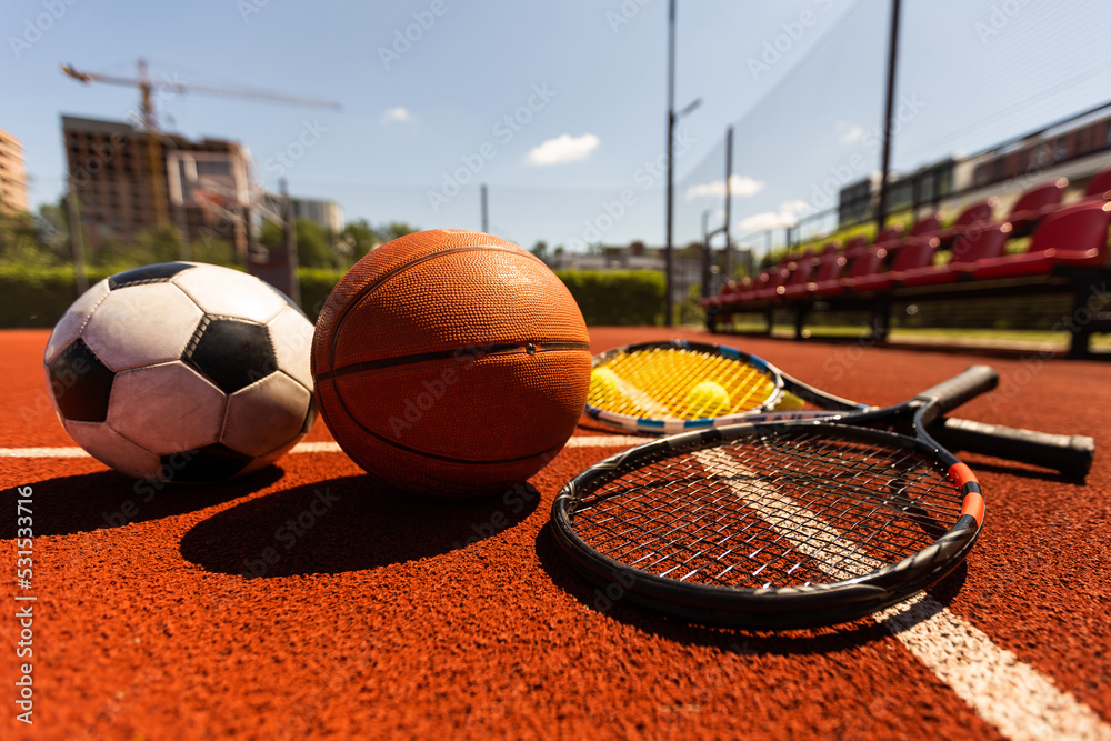 Set of sport equipment, rackets and tennis balls soccer and basketball balls