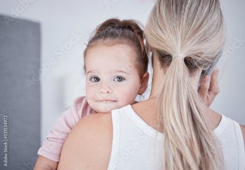 Baby, communication and mom talking in phone call conversation while multitasking on business call. Work from home single mother holding a little girl, child or kid while speaking on a mobile