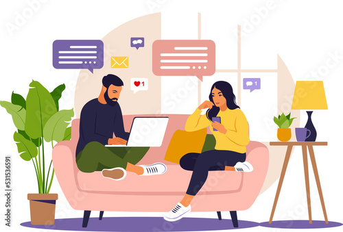 Women and man sitting in a sofa and working online at home. Freelance, online education or social media concept.
