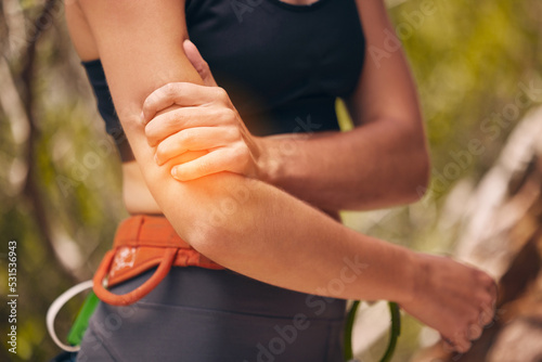 Woman, arm injury and pain while hiking, mountain climbing or fitness training outdoors in nature. Female sports athlete with medical joint inflammation from intense exercise in the countryside.