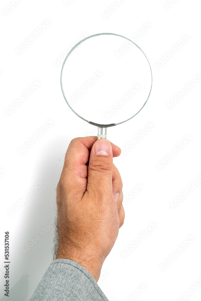 Man's hand, holding classic styled magnifying glass, closeup isolated on white background, copy space for your image or text Man's hand, holding classic styled magnifying glass, closeup isolated on white background, copy space for your image or text