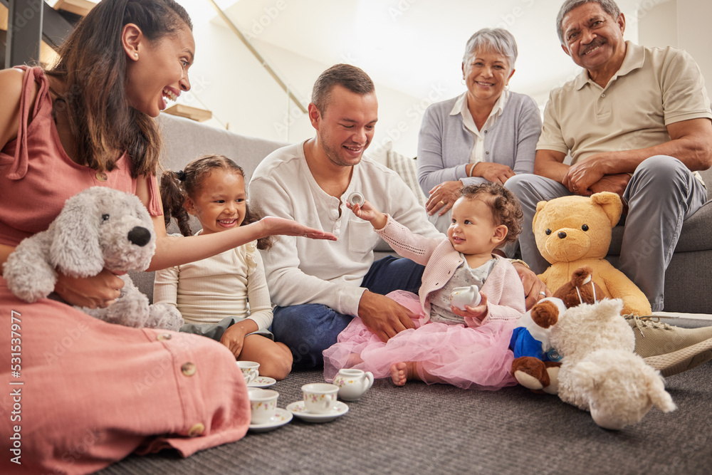 Big family portrait in kids room with tea party toys for play and bonding together on the floor. Happy grandparents, mother and father with baby in their family home having fun sitting on the ground Big family portrait in kids room with tea party toys for play and bonding together on the floor. Happy grandparents, mother and father with baby in their family home having fun sitting on the ground