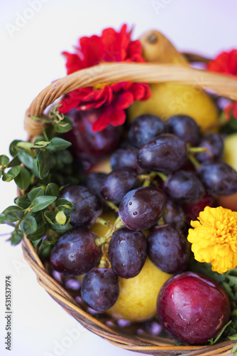 Wicker basket with fruits and flowers
