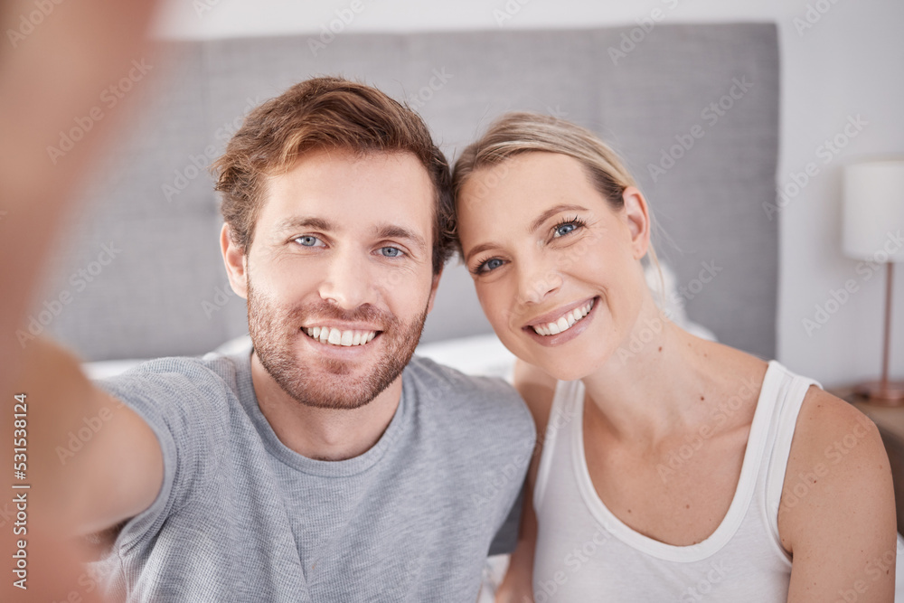 A selfie in bedroom of man and woman as couple. Portrait of young, happy and smiling people taking a picture together in the morning and wearing pajamas. Taking a photo with smile, bonding and love A selfie in bedroom of man and woman as couple. Portrait of young, happy and smiling people taking a picture together in the morning and wearing pajamas. Taking a photo with smile, bonding and love