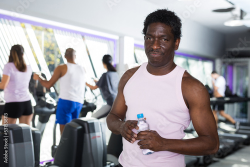 Man with bottle of water in a sports club