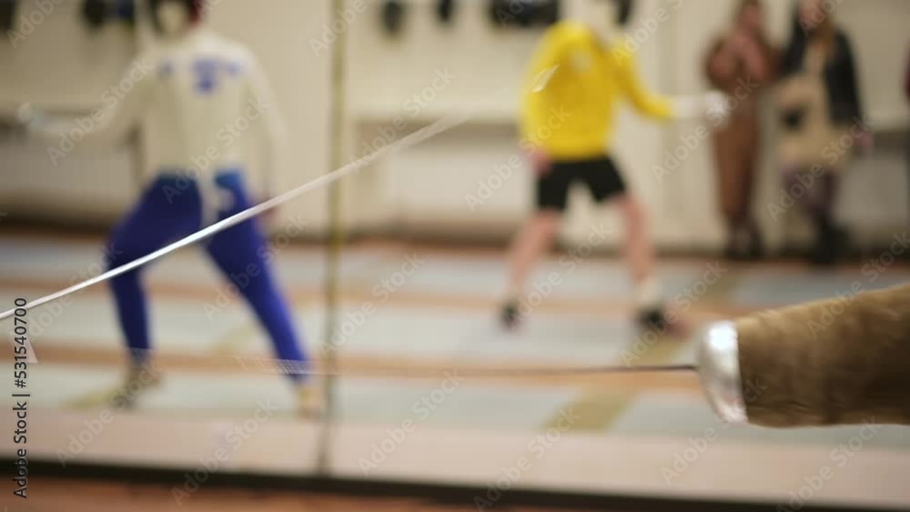Close-up of fencers practicing an
attack in sporthall. Fencing training slow-motion Close-up of fencers practicing an
attack in sporthall. Fencing training slow-motion
