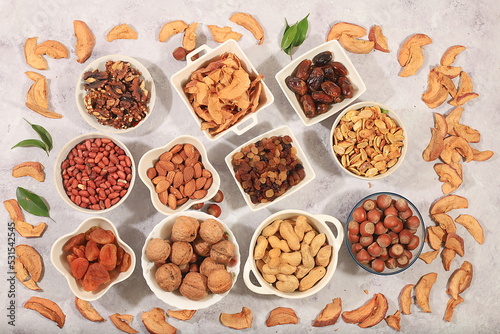 Assortment of various nuts and dried fruits, healthy natural food concept, almonds, nuts, pecans, pistachios, cashews, walnuts and pine nuts, apples, raisins, dried apricots, f
