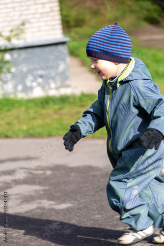 A two-year-old little toddler boy runs away in the fall