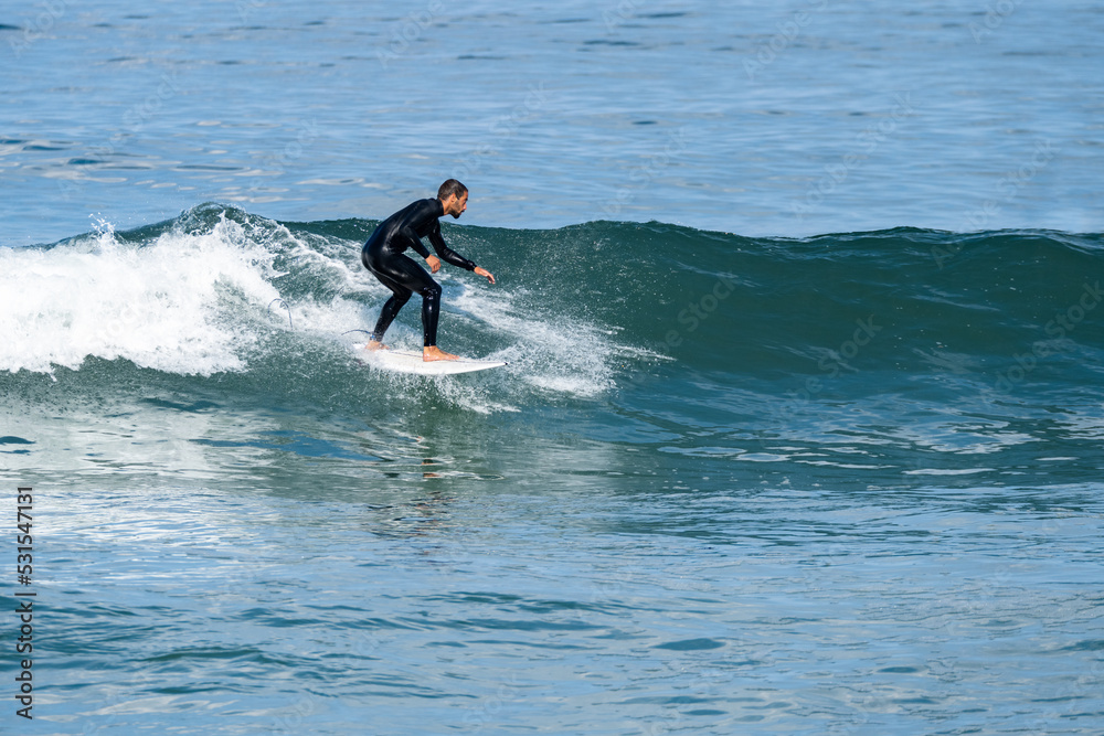 Surfer riding waves