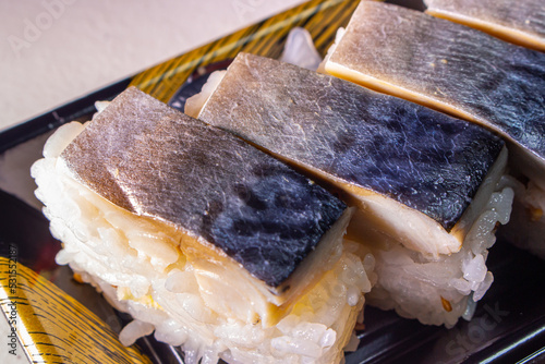 Takeout Saba Sushi (Saba Oshizushi, Mackerel Pressed Sushi) in plastic food container. Oshi Zushi is the one of forms of sushi which made by compressing sushi rice with fish and other toppings photo