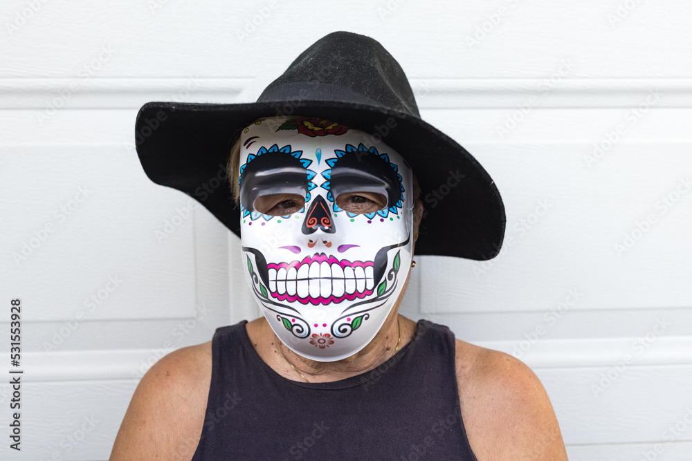 Portrait of an elderly lady with a catrina mask and hat, celebrating  Halloween and All Souls' Day, on a white background. Celebration, costume,  party and mask concept. Stock Photo | Adobe Stock