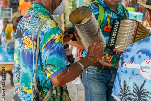 Dominican Republic. The beach musician plays the guiro. Merengue music. Traditional Latin American music. photo