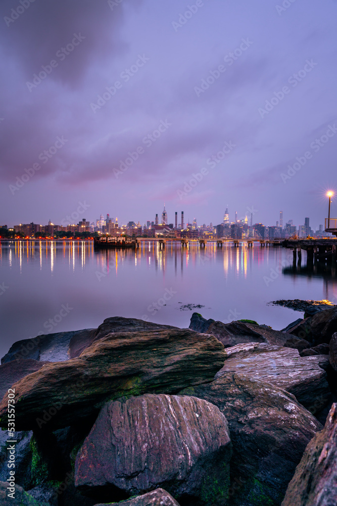 city skyline at night beautiful reflection panorama manhattan urban lights water river rocks sky New York  