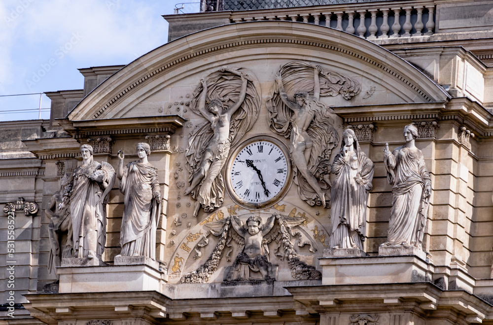 Details of a clock and statues in a palace