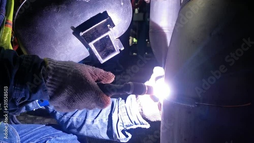 Professional Welder Wears Helmet Working in Heavy Industry Process Pipe, Welding Piping Construction of the Oil, Natural Gas and Fuels Transport Pipeline. Industrial Manufacturing Factory.
