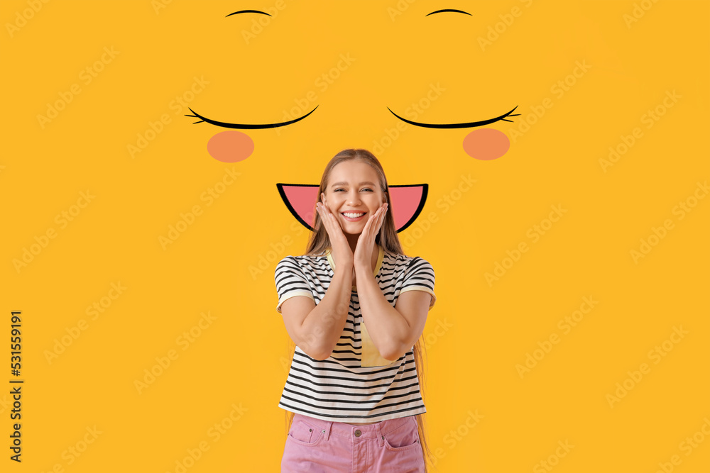 Happy young woman and drawn smile on yellow background Happy young woman and drawn smile on yellow background
