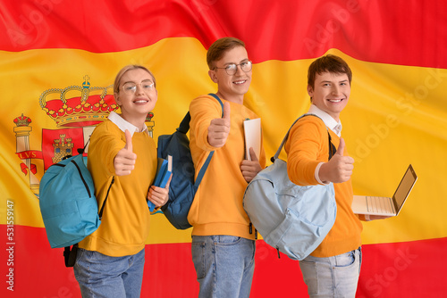 Young students showing thum...