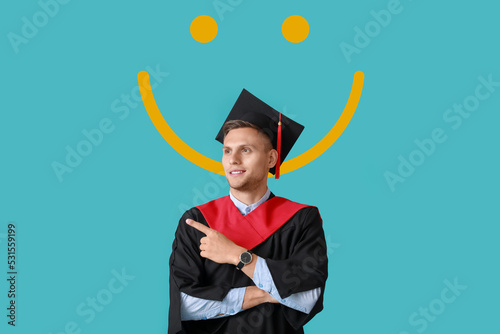 Male graduating student poi...