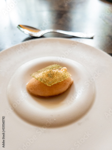 A palate cleanser of peach sorbet on a plate