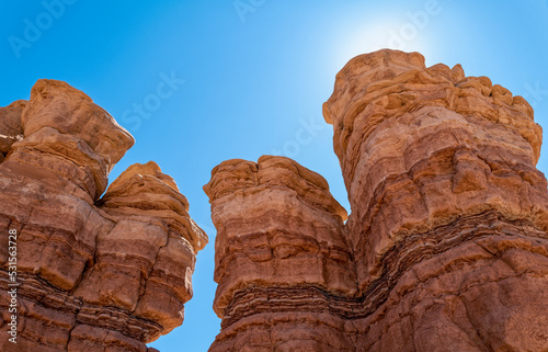 The peaks of backlit rock formations along Notom Road Scenic Backway near Capitol Reef National Park, Utah, USA