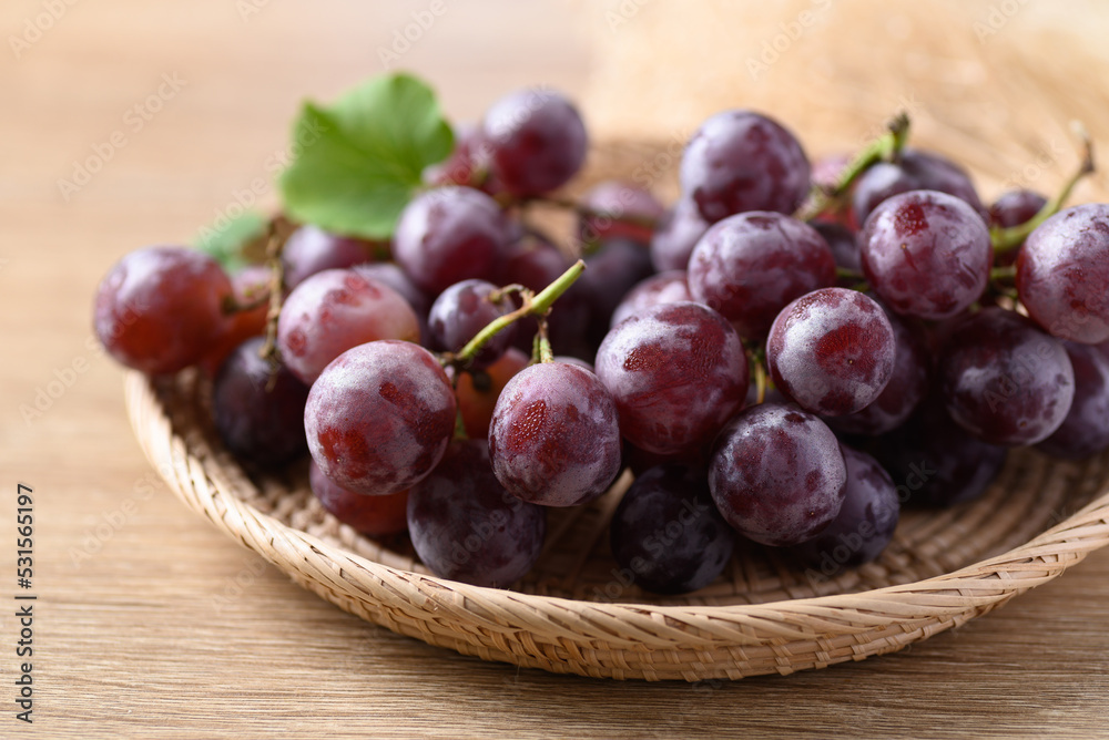 Red grape in basket on wooden background, Healthy fruit Red grape in basket on wooden background, Healthy fruit