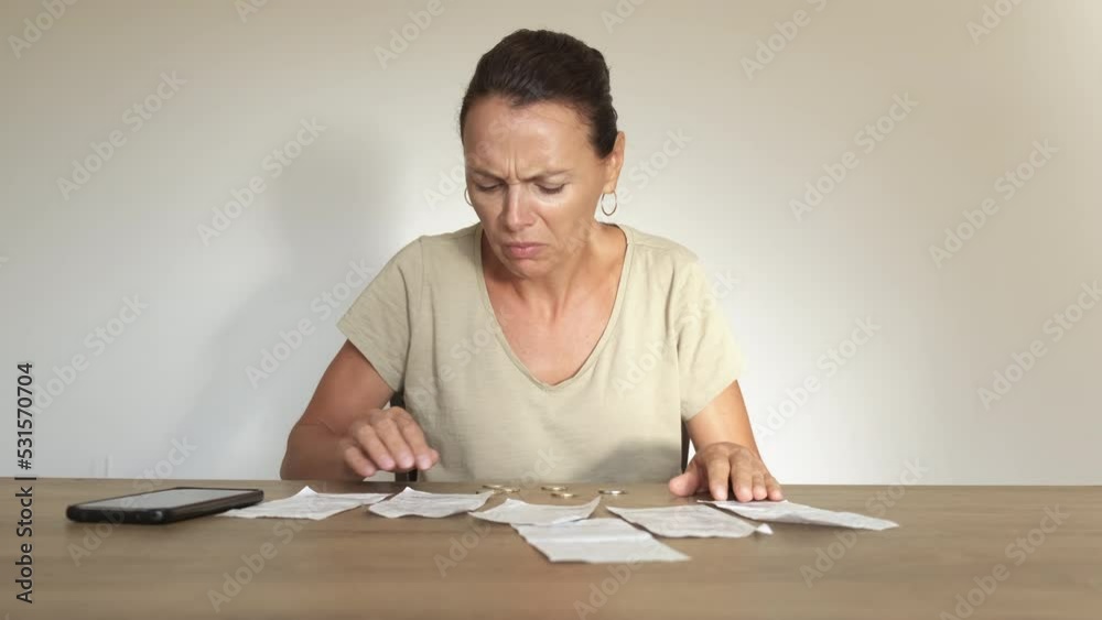 Bills for electricity inflation indoor. A pensive woman expect bills for electricity during economical crisis in the world. Bills for electricity inflation indoor. A pensive woman expect bills for electricity during economical crisis in the world.
