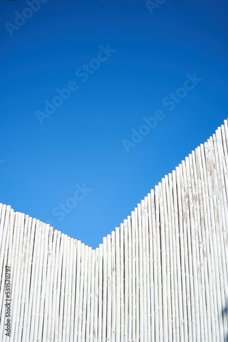 White wooden wall against blue sky