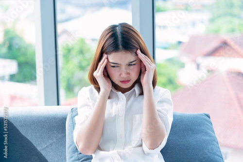 Stress asian women headache have migraine feeling temples stressfull upset depressed. Strong headache migraine exhausted young girl. Office syndrome unhealthy Tension person. Woman headache concept photo