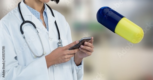 Digital illustration of a doctor using a smartphone with a giant medical pill floating by her 