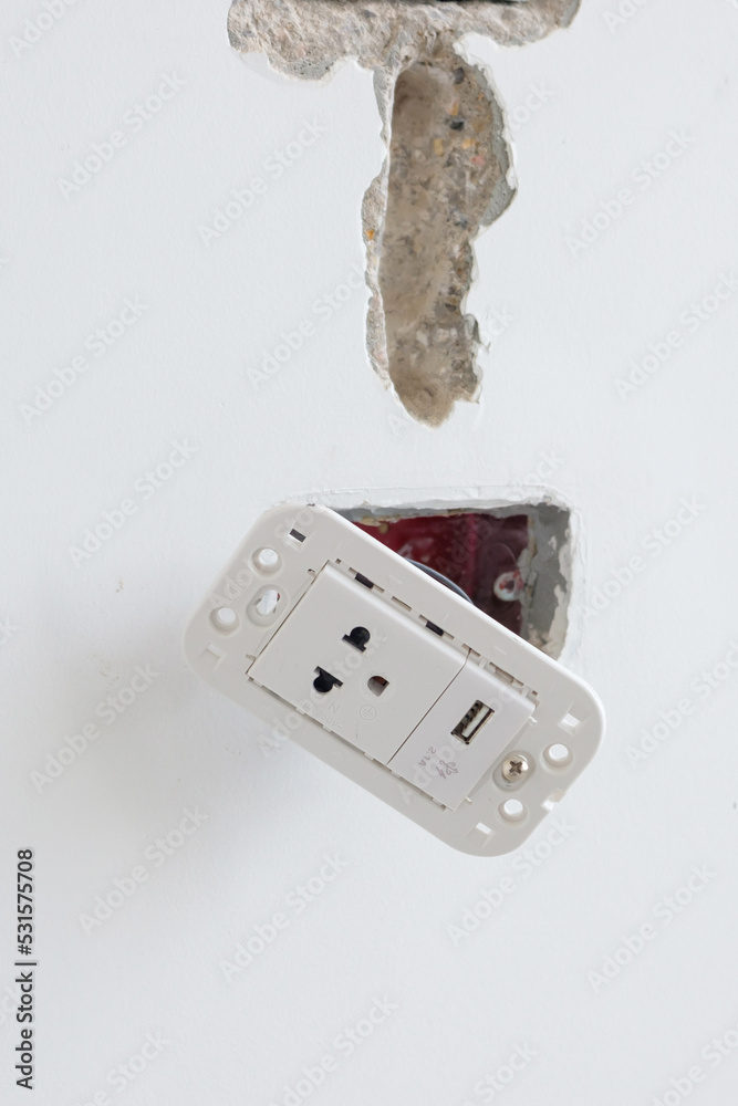 Electrical Wiring under plaster, hidden installation cables for socket to a concrete. Renovation, Repair and development of home and apartment concepts Electrical Wiring under plaster, hidden installation cables for socket to a concrete. Renovation, Repair and development of home and apartment concepts