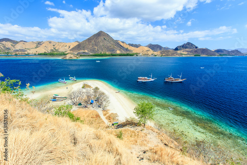 Fototapeta Naklejka Na Ścianę i Meble -  Panorama view of beaches and tourist boat sailing in Kelor Island, Flores Island, Indonesia