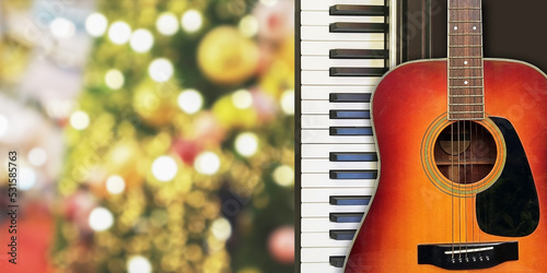 Photography Christmas and New Year celebration with piano and acoustic guitar musical instruments for holiday party on romantic bokeh blur background