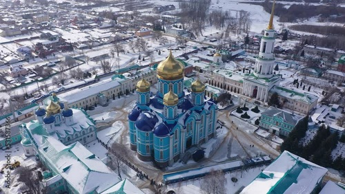 Aerial panoramic view of architectural complex of Nativity of Mother of God Monastery in small Russian town of Zadonsk on winter day photo