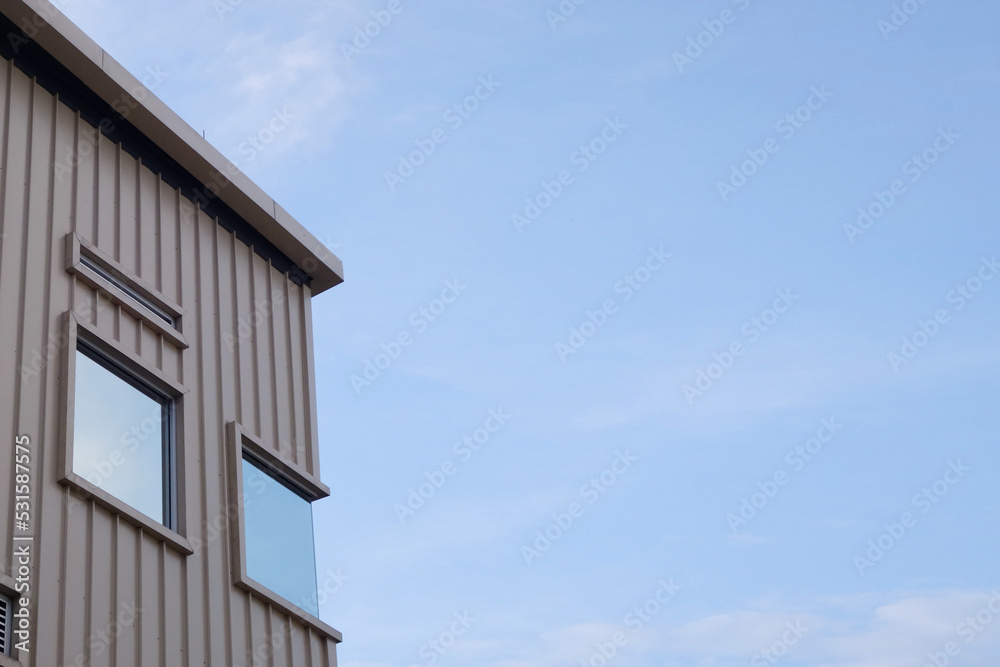 Modern urban apartment building exterior in evening.