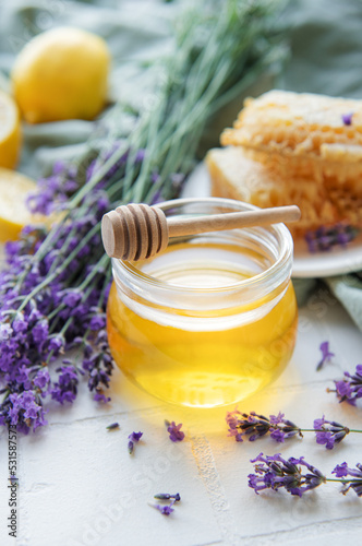 Jar with honey and fresh lavender flowers