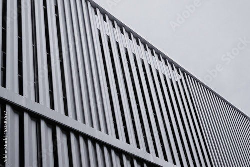 Modern urban apartment building exterior in evening.