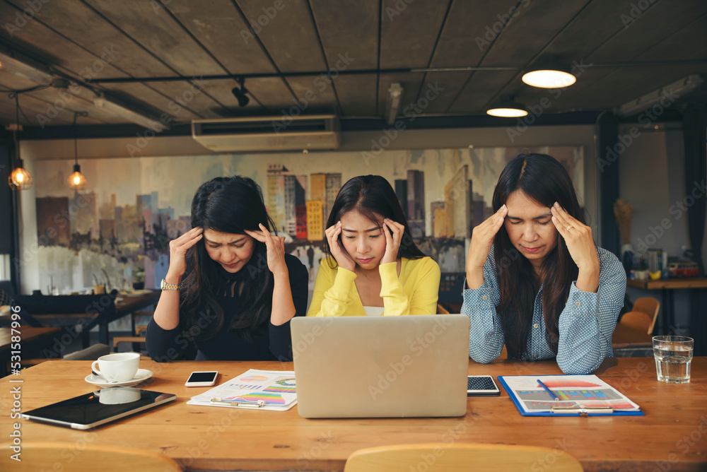 Stressed businesspeople, Frustrated and upset in business pressure and overworked at office. Group of Adult Asian woman working on laptop, feeling tire and headache. Stressed and Frustrated concept. Stressed businesspeople, Frustrated and upset in business pressure and overworked at office. Group of Adult Asian woman working on laptop, feeling tire and headache. Stressed and Frustrated concept.