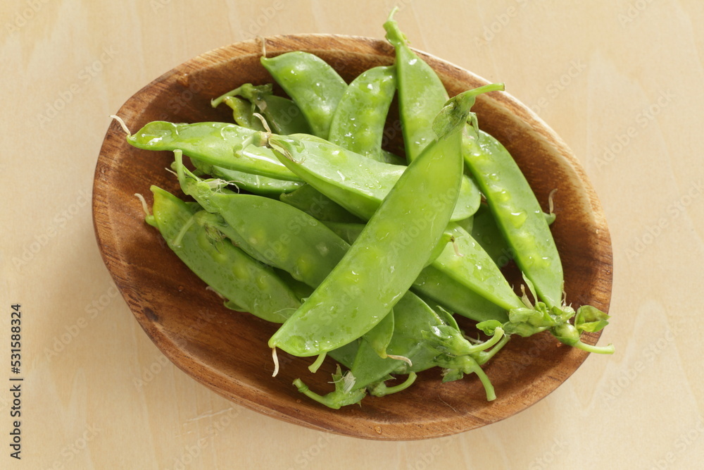 Freshness pea on wooden plate for cooking image Freshness pea on wooden plate for cooking image